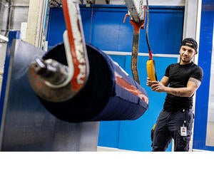 An Associate working with a role of laminate